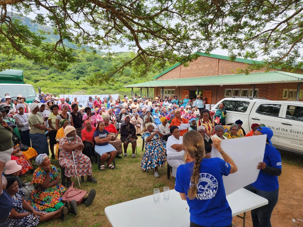 Rural community gathered for a PureFlow Amanzi system distribution and WASH education event