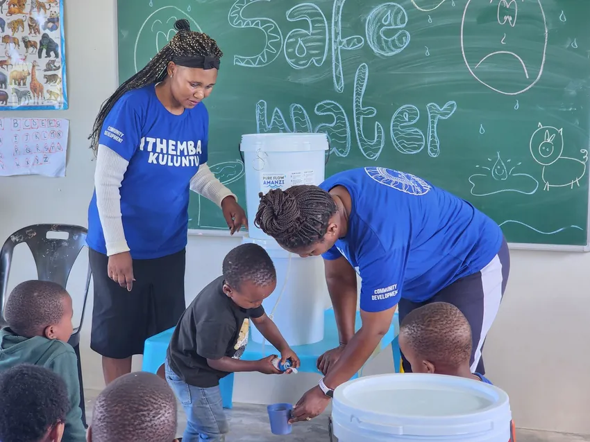 Children learning about clean water through a practical demonstration at an ECD centre